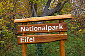 Signpost „Eifel National Park“ at Eifelsteig hiking trail, North Rhine-Westphalia, Germany, Europe