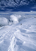 Woman descending snowy slope in the Sierra Nevada Mountains, Andalucia, Spain