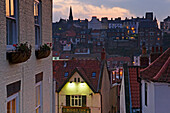 Sunset view of rooftops in the historic town of Whitby, North Yorkshire, England, United Kingdom.