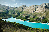 Turquoise blue damming lake in Guadalest surrounded by mountains, Costa Blanca, Spain