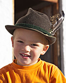 Boy (8-9 years) smiling at camera, Hofbauern-Alm, Kampenwand, Chiemgau, Upper Bavaria, Germany