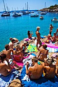 Group of people on the beach. Cala Salada beach. Santa Agnés de Corona. Ibiza. Balearic Islands. Spain