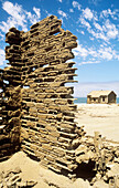Namibia - In the Namib Desert inside the restricted Diamond Area south of Lüderitz: The Elizabeth Bay ghost town of the diamond days with its old walls of resistent matrix and dissolving bricks which disappear due to the continuous onslaught of wind and s