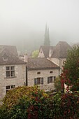 France, Midi-Pyrenees Region, Lot Department, St-Cirq-Lapopie, town overview in fog