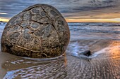 Moeraki boulders at dawn as SW front passes overhead, near Oamaru, Otago