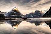 Mitre peak, winter dawn, cold mist rising from Milford Sound, Fiordland National Park
