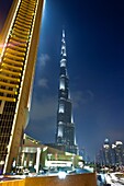 The Burj Al Khalifa tower illuminated at night near the Dubai Mall in Dubai, UAE