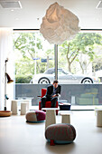 Guest in the Lobby with designer furniture, Citizen M Hotel, Amsterdam, Netherlands