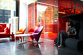 Guest in the Lobby with designer furniture, Citizen M Hotel, Amsterdam, Netherlands