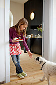 Girl with a dog in a hotel breakfast room, Fincken, Mecklenburg-Western Pomerania, Germany