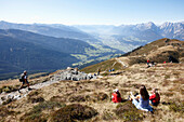 Familie sitzt auf einer Wiese beim Naturhotel Grafenast, Am Hochpillberg, Schwaz, Tirol, Österreich