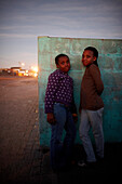 Children in front of a wall at Guguletu Township in the evening, Cape Flats, Cape Town, South Africa, Africa