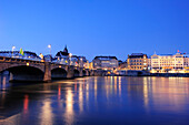 Illuminated city of Basel with river Rhine in foreground, Basel, Switzerland