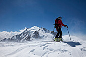 Ski mountaineer on Mont Blanc du Tacul, overlooking Mont Maudit and Mont Blanc, Chamonix-Mont-Blanc, France