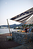 Couple having drinks at the Veghera Bar, Elounda Beach Resort, Elounda, Crete, Greece