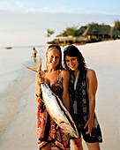 Tourists with bought Yellowtail Tuna for a birthday party, Nungwi, Zanzibar, Tanzania, East Africa