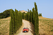Vintage car on a country road at the Montalcino region, Tuscany, Italy, Europe