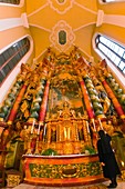 A nun lighting candles for Sunday Mass, Monastery of Our Lady of Offenburg Capuchin Monastery, Offenburg, Baden-Württemberg, Germany