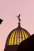 Statue of an angel holding the ´Trumpet of Fame´ atop the glass dome known as the Lemon Squeezer Zitronenpresse on the Kunstakademie Art Academy, Dresden, Saxony, Germany