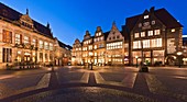 Panoramic view of illuminated houses and the House Schuetting in Bremen in the evening, Germany, Europe