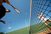 action, activity, adult, ball, blue, blue sky, Caucasian ethnicity, Color image, contemporary, couple, day, Female, fit, health, healthy, horizontal, human, In good shape, In shape, Keeping fit, leisure, Male, Man, net, outdoor, pair, people, player, rack