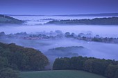Church and Village of South Harting rising out of the mist at dawn on the South Downs West Sussex
