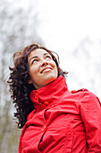 Content woman looking at the sky in the park