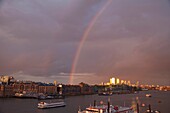 England, London, Rainbow over Docklands Skyline and River Thames