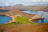 Rock formation Pinnacle Rock on Island Bartolome, in the background Isla Santiago, Galapagos, Ecuador, South America