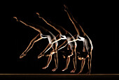 multiple images of gymnast on beam. multiple images of gymnast on beam