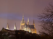 Cathedral lit up at night. The Cathedral of St Vitus is located within Prague Castle. It sits of the site of several religious buildings dedicated to St Vitus since the 10th century