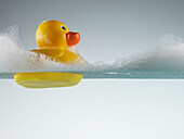 Rubber duck floating in soapy water. Rubber duck floating in soapy water