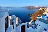 Caldera view with ferry in early morning in the town of Oia in Santorini, Greece