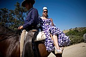 Riders wear traditional Andalusian clothes during a romeria, or pilgrimage, in honor of San Isidro Labrador, the patron of farmers, in Prado del Rey village, Cadiz Province, Andalusia, Spain.