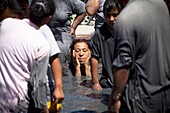 A woman bathes in a pool of mud believed to have healing powers at Nino Fidencio celebrations in Espinazo, Nuevo Leon state, Mexico.