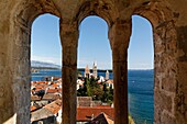 View of Rab Town through arch of Roman bell tower in Rab, Croatia, Europe
