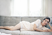 Woman lying on a sofa
