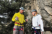 Young woman and young man preparing for fixed rope route Rino Pisetta, Lago die Toblino, Sarche, Calavino, Trentino, Trentino-Alto Adige, Suedtirol, Italy