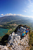 Young woman and young man climbing fixed rope route Rino Pisetta, Lago die Toblino, Sarche, Calavino, Trentino, Trentino-Alto Adige, Suedtirol, Italy
