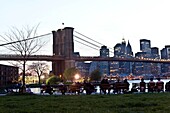 New York - United States, People gazing the skyline of Manhattan and the East river, in Brooklyn bridge park, under the Manhattan bridge