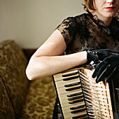 Woman in Black Lace Dress and Gloves With Accordian