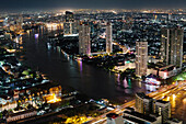 View of Chao Phraya River, and the city centre at night. Buildings lit up, and skyscrapers illuminated against the evening sky. Modern downtown area. Tall buildings., Bangkok, Thailand/skyline