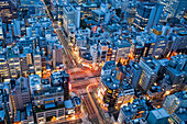 Downtown Tokyo road intersection at Dusk. View from above. A densely built on urban area, a centre of population., Downtown Tokyo Intersection at Dusk
