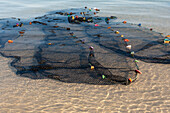 Fishing nets spread out in the shallow water on the shore in Ankasy, southwestern Madagascar, Fishing net in shallow water
