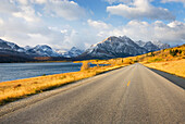 Autumn along the Going To The Sun Road. Lake shore road, in the national park, with views of snowcapped mountains. Glacier National Park, Montana. USA, Glacier National Park Montana