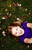 Young Smiling Girl Laying on Ground