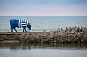 Sculpture Sailor Cow on the Southern breakwater of harbor is part of the Ventspils CowParade art project, Ventspils, Latvia, Baltic States, Europe
