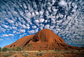 Ayers Rock under white clouds, Uluru Kata Tjuta National Park, Northern Territory, Australia