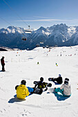 Children snowboarding, piste at ski resort Motta Naluns, Unterengadin, Switzerland