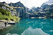 Angler at lake Oeschinensee, Kandersteg, Bernese Oberland, Canton of Bern, Switzerland, Europe